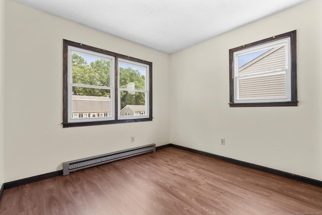 83 Julia Ter, Middletown, CT 06457 - spare room featuring a baseboard radiator, healthy amount of natural light, and wood finished floors