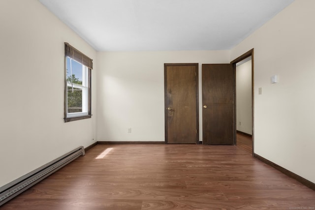 83 Julia Ter, Middletown, CT 06457 - unfurnished bedroom with a baseboard heating unit and wood finished floors
