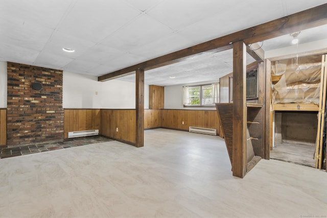 83 Julia Ter, Middletown, CT 06457 - below grade area with a baseboard heating unit, wooden walls, and wainscoting
