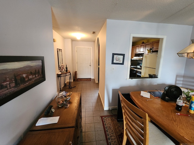 2390 State St Apt 7D, Hamden, CT 06517 - office area featuring dark tile patterned floors, a textured ceiling, and arched walkways