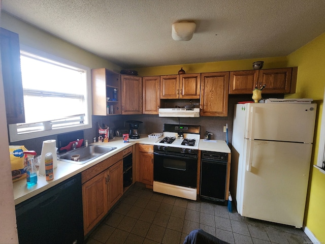 2390 State St Apt 7D, Hamden, CT 06517 - kitchen with freestanding refrigerator, gas range, black dishwasher, under cabinet range hood, and dark tile patterned flooring