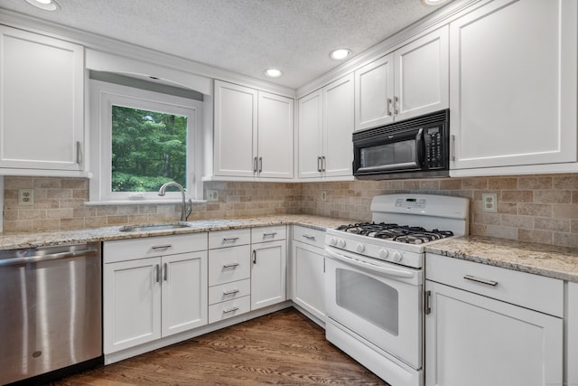 70 Brighton Rd, Hebron, CT 06248 - kitchen featuring stainless steel dishwasher, black microwave, white range with gas stovetop, white cabinets, and a textured ceiling