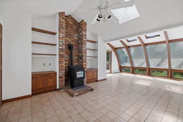 70 Brighton Rd, Hebron, CT 06248 - unfurnished living room featuring a skylight, a ceiling fan, built in shelves, a wood stove, and baseboard heating