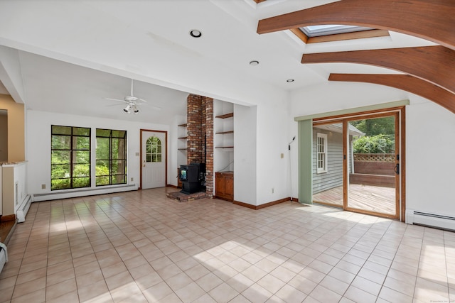 70 Brighton Rd, Hebron, CT 06248 - unfurnished living room featuring baseboard heating, a wood stove, healthy amount of natural light, built in shelves, and recessed lighting
