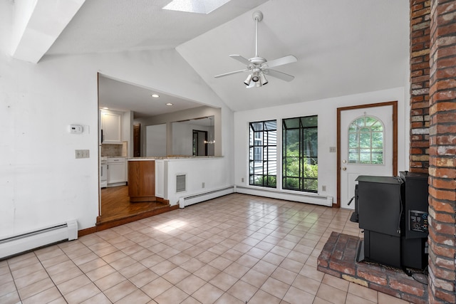 70 Brighton Rd, Hebron, CT 06248 - unfurnished living room featuring a baseboard radiator, vaulted ceiling, a ceiling fan, light tile patterned flooring, and a skylight