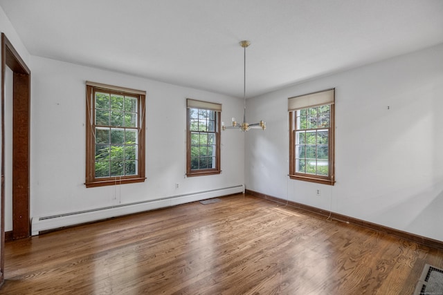 70 Brighton Rd, Hebron, CT 06248 - spare room with baseboard heating, healthy amount of natural light, wood finished floors, and a chandelier