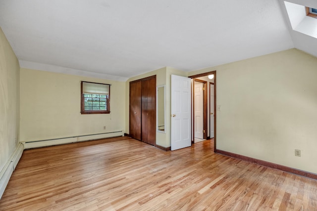 70 Brighton Rd, Hebron, CT 06248 - unfurnished bedroom with baseboard heating, light wood-style flooring, a skylight, and a closet