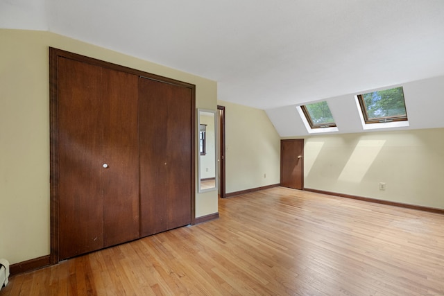 70 Brighton Rd, Hebron, CT 06248 - bonus room featuring a skylight, light wood finished floors, vaulted ceiling, and a baseboard heating unit