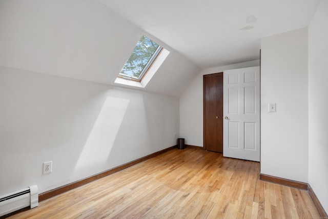70 Brighton Rd, Hebron, CT 06248 - additional living space featuring baseboard heating, lofted ceiling, a skylight, and light wood-style floors