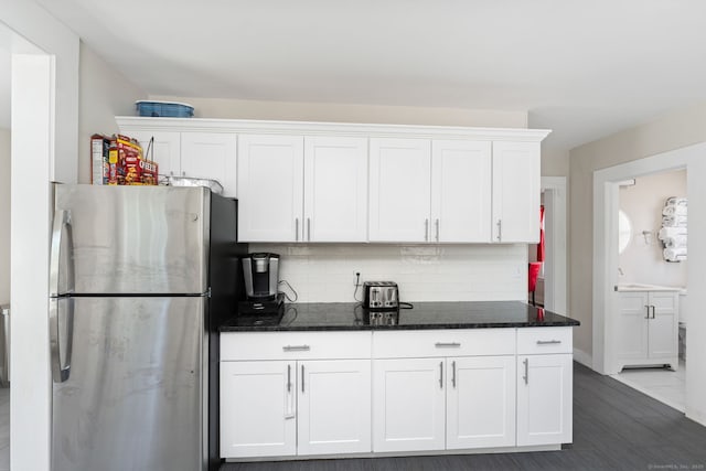 163 Willetts Ave, New London, CT 06320 - kitchen with freestanding refrigerator, white cabinetry, backsplash, and dark stone counters
