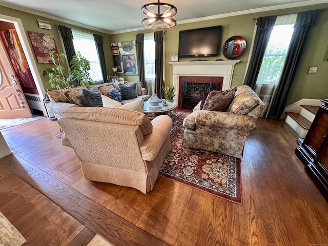 34 Federal St, West Hartford, CT 06110 - living room with wood finished floors, a fireplace, ornamental molding, and a baseboard heating unit
