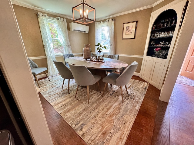 34 Federal St, West Hartford, CT 06110 - dining room with a wall unit AC, crown molding, wood finished floors, built in features, and a chandelier