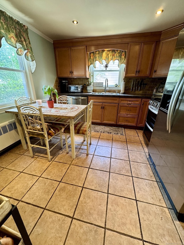 34 Federal St, West Hartford, CT 06110 - kitchen with range with two ovens, refrigerator, decorative backsplash, crown molding, and dark countertops
