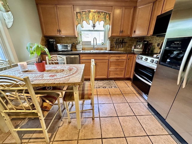 34 Federal St, West Hartford, CT 06110 - kitchen featuring stainless steel appliances, tasteful backsplash, dark countertops, and light tile patterned floors