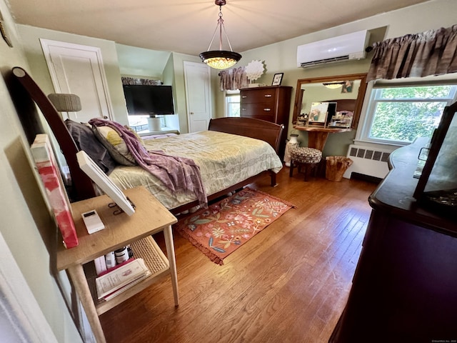 34 Federal St, West Hartford, CT 06110 - bedroom with a wall mounted AC, radiator, and wood finished floors