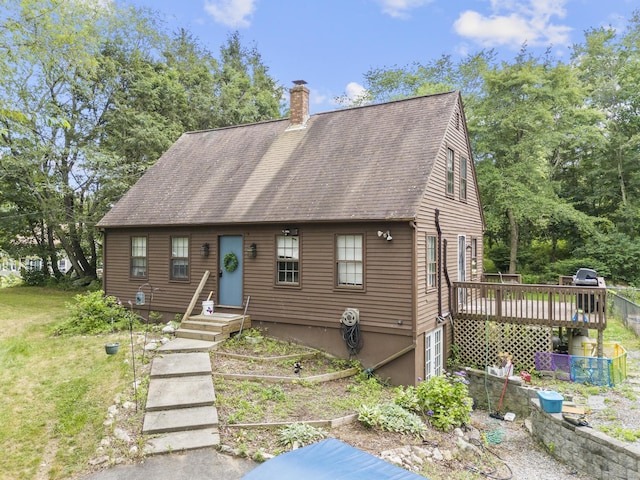 64 Iron St, Ledyard, CT 06339 - cape cod home featuring a chimney, a wooden deck, and roof with shingles