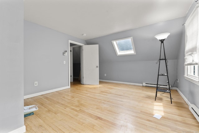 64 Iron St, Ledyard, CT 06339 - unfurnished bedroom with a skylight, wood finished floors, a baseboard heating unit, and vaulted ceiling