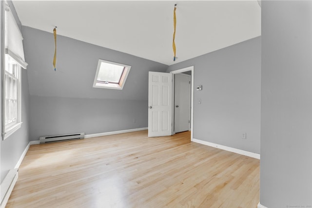 64 Iron St, Ledyard, CT 06339 - bonus room featuring baseboard heating, a skylight, wood finished floors, vaulted ceiling, and a baseboard heating unit