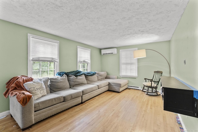 64 Iron St, Ledyard, CT 06339 - living room featuring a wall unit AC, hardwood / wood-style flooring, baseboard heating, and a textured ceiling