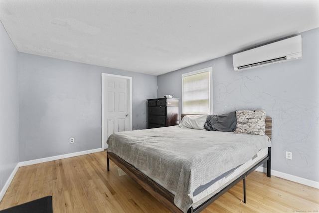 64 Iron St, Ledyard, CT 06339 - bedroom with a wall mounted air conditioner and wood finished floors