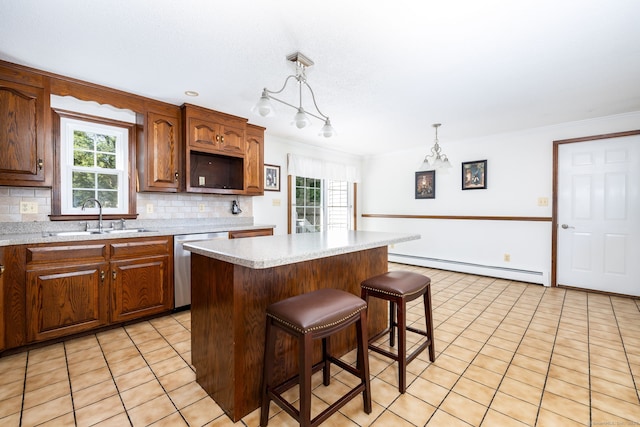 10 Empire Way, Bristol, CT 06010 - kitchen with a baseboard radiator, dishwasher, light countertops, tasteful backsplash, and light tile patterned floors