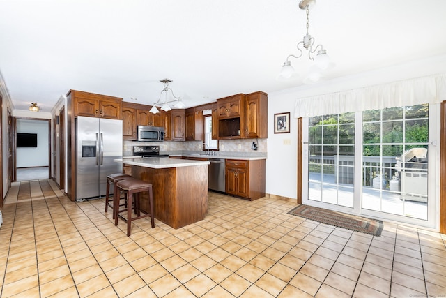 10 Empire Way, Bristol, CT 06010 - kitchen featuring appliances with stainless steel finishes, a chandelier, crown molding, a center island, and light countertops