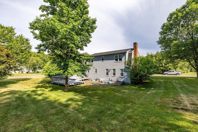 10 Empire Way, Bristol, CT 06010 - rear view of house featuring a chimney, a wooden deck, and a yard