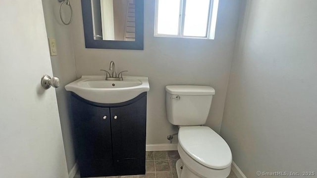 half bathroom featuring vanity and tile patterned floors