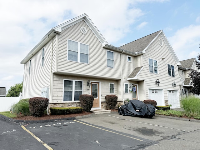 280 Booth St Unit B5, New Britain, CT 06053 - townhome / multi-family property featuring stone siding, uncovered parking, an attached garage, and entry steps