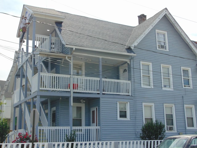 69 W Liberty St, Waterbury, CT 06706 - back of house featuring a chimney, roof with shingles, and a porch