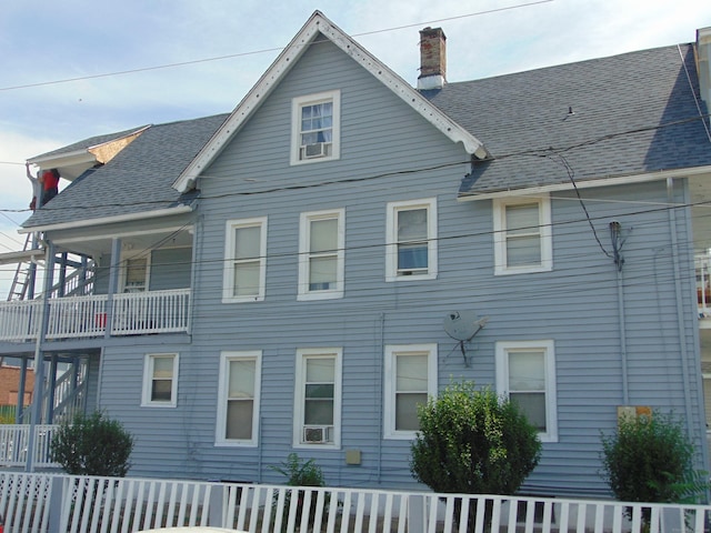69 W Liberty St, Waterbury, CT 06706 - rear view of house featuring a chimney