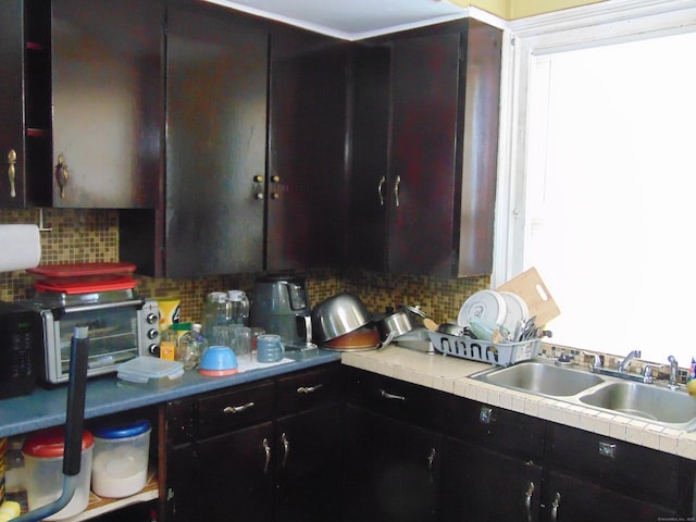 69 W Liberty St, Waterbury, CT 06706 - kitchen featuring decorative backsplash and healthy amount of natural light