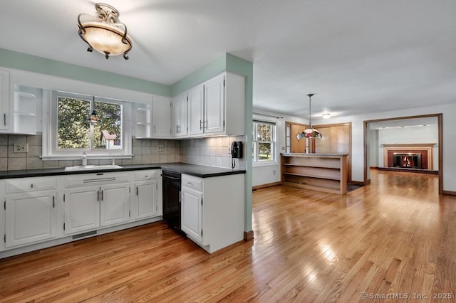 151 Timber Trl, East Hartford, CT 06118 - kitchen featuring black dishwasher, dark countertops, open shelves, light wood finished floors, and white cabinetry