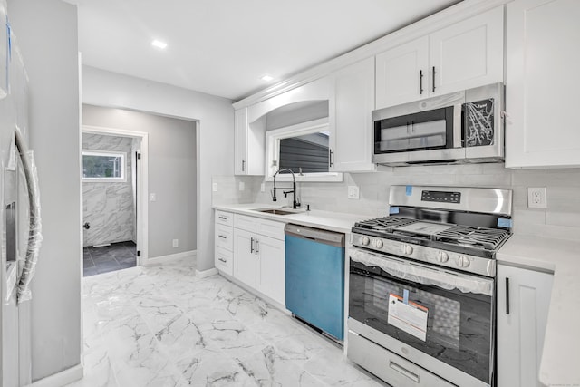 34 2nd Ave, East Haven, CT 06512 - kitchen with stainless steel appliances, light marble finish flooring, light countertops, white cabinetry, and backsplash