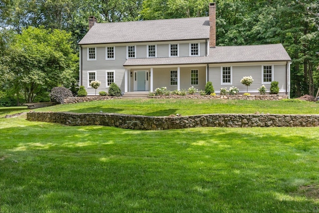 392 Hoyt Farm Rd, New Canaan, CT 06840 - colonial home featuring a chimney, a front yard, a shingled roof, and a porch