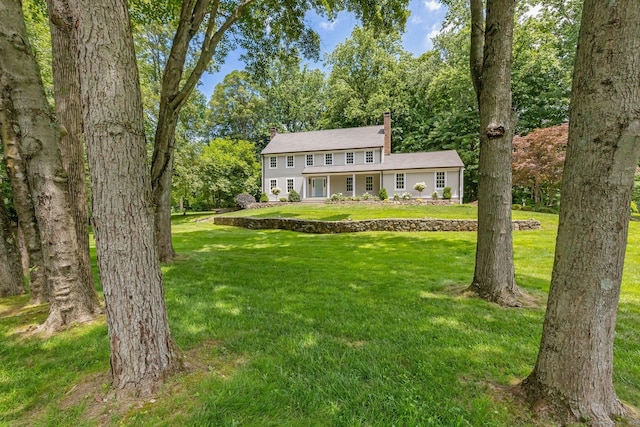 392 Hoyt Farm Rd, New Canaan, CT 06840 - colonial home with a chimney and a front lawn