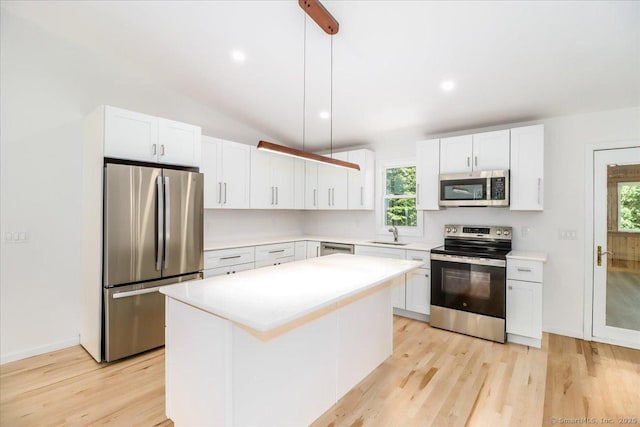 36 Jotham Rd, New Milford, CT 06776 - kitchen featuring stainless steel appliances, light wood-type flooring, white cabinets, healthy amount of natural light, and vaulted ceiling