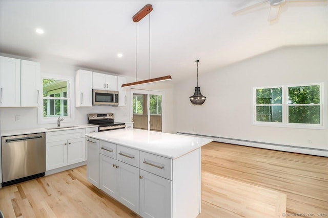 36 Jotham Rd, New Milford, CT 06776 - kitchen featuring stainless steel appliances, a baseboard heating unit, light wood finished floors, white cabinetry, and lofted ceiling