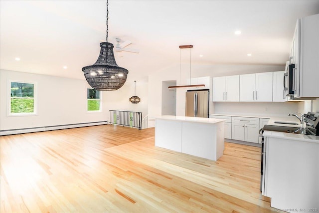 36 Jotham Rd, New Milford, CT 06776 - kitchen with appliances with stainless steel finishes, a baseboard radiator, light wood finished floors, vaulted ceiling, and a center island