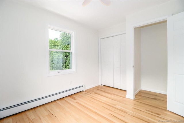 36 Jotham Rd, New Milford, CT 06776 - unfurnished bedroom featuring a baseboard heating unit, light wood-type flooring, a closet, and a ceiling fan