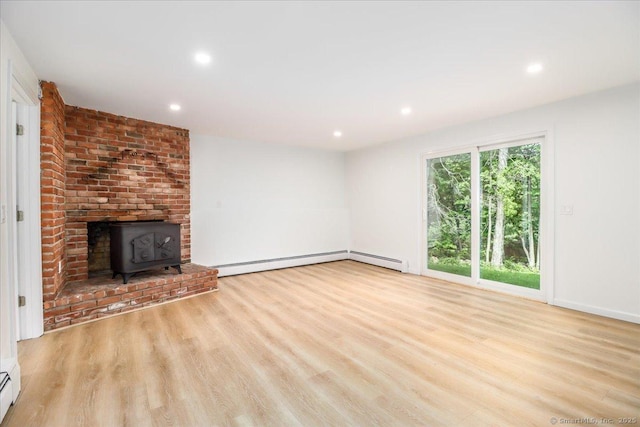 36 Jotham Rd, New Milford, CT 06776 - unfurnished living room with a wood stove, wood finished floors, recessed lighting, and baseboard heating
