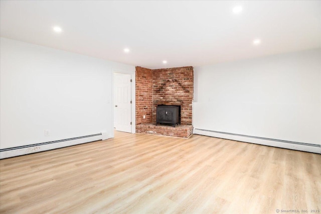 36 Jotham Rd, New Milford, CT 06776 - unfurnished living room featuring a baseboard radiator, wood finished floors, a wood stove, and recessed lighting