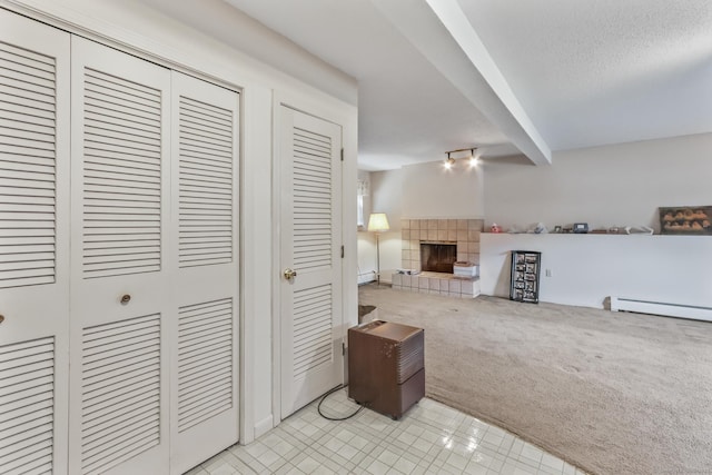 55 Grickis Ln, Naugatuck, CT 06770 - living area featuring a baseboard heating unit, light carpet, a tile fireplace, and light tile patterned floors