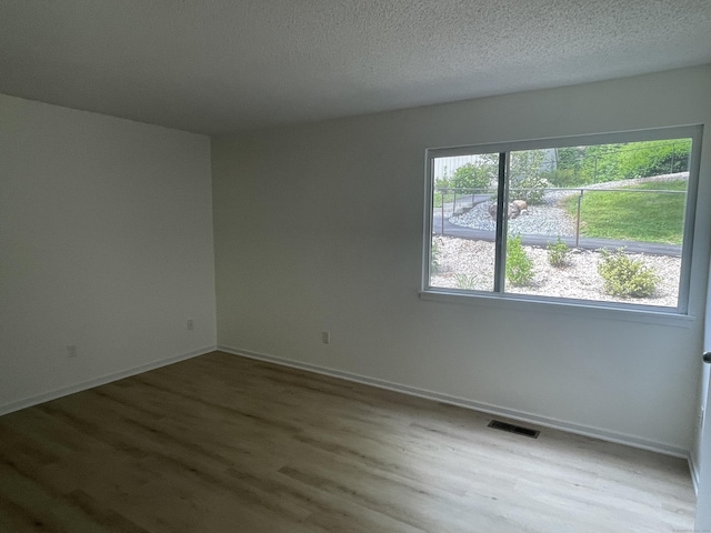 277 Heritage Vlg Unit C, Southbury, CT 06488 - empty room featuring wood finished floors and a textured ceiling