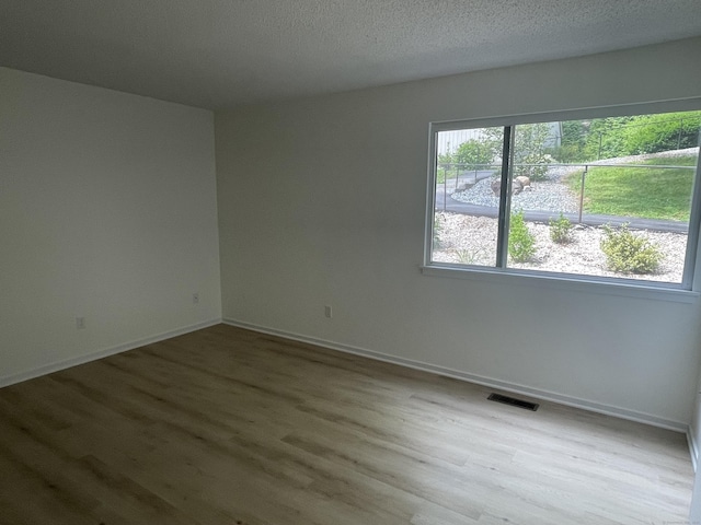 277 Heritage Vlg Unit C, Southbury, CT 06488 - empty room featuring wood finished floors and a textured ceiling