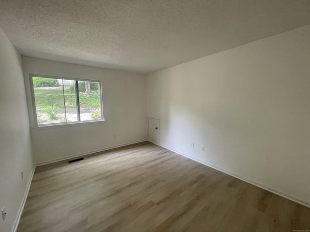 277 Heritage Vlg Unit C, Southbury, CT 06488 - empty room featuring wood finished floors and a textured ceiling