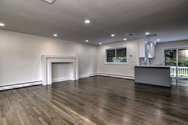 13 School St, Monroe, CT 06468 - unfurnished living room with a baseboard heating unit, dark wood-style floors, and recessed lighting