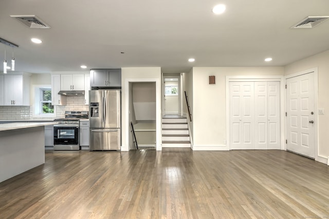 13 School St, Monroe, CT 06468 - kitchen with appliances with stainless steel finishes, dark wood-type flooring, under cabinet range hood, decorative backsplash, and recessed lighting
