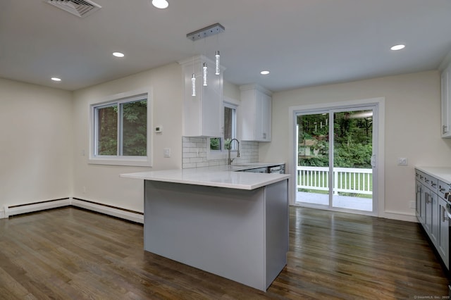 13 School St, Monroe, CT 06468 - kitchen featuring dark wood-type flooring, light countertops, a peninsula, recessed lighting, and decorative backsplash
