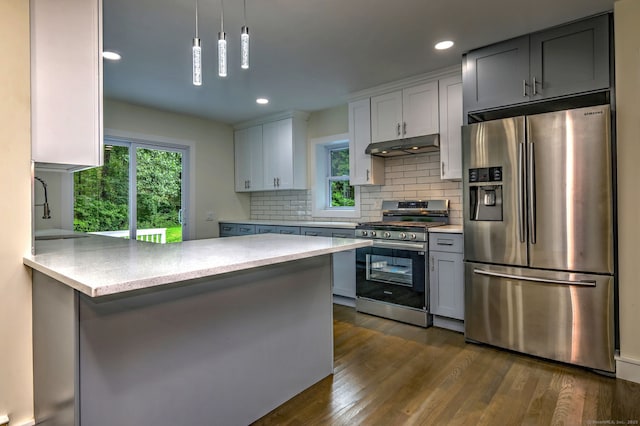 13 School St, Monroe, CT 06468 - kitchen featuring appliances with stainless steel finishes, under cabinet range hood, plenty of natural light, tasteful backsplash, and recessed lighting